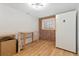Finished basement area with exposed brick, wooden flooring, refrigerator and room for storage at 11542 W 67Th Way, Arvada, CO 80004
