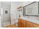 Modern bathroom featuring walk-in shower, bright marble countertops and wooden shelving at 11542 W 67Th Way, Arvada, CO 80004