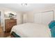 Comfortable bedroom featuring dark hardwood floors, tv and modern ceiling light at 11542 W 67Th Way, Arvada, CO 80004