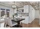 Elegant dining area featuring wainscoting, built-in cabinets, and designer light fixture at 11542 W 67Th Way, Arvada, CO 80004