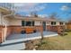 Charming home featuring a brick facade, blue door, and inviting front porch at 11542 W 67Th Way, Arvada, CO 80004