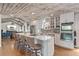 A kitchen island with seating, stainless steel appliances, and access to the living room at 11542 W 67Th Way, Arvada, CO 80004