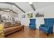 A well decorated living room with wooden beams, hard wood floors, and rustic decor at 11542 W 67Th Way, Arvada, CO 80004
