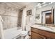 Bathroom featuring tiled shower-tub with framed mirror and granite countertops at 5157 S Sedalia Ct, Centennial, CO 80015