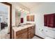 Bathroom featuring granite countertop vanity with mirror and wood cabinet at 5157 S Sedalia Ct, Centennial, CO 80015