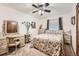 Bedroom with a floral comforter, ceiling fan, and desk with chair at 5157 S Sedalia Ct, Centennial, CO 80015