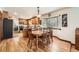 Bright dining area with hardwood floors, a bay window, and adjacent kitchen access at 5157 S Sedalia Ct, Centennial, CO 80015