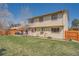 Back exterior of home with patio and outdoor seating against a bright blue sky at 5157 S Sedalia Ct, Centennial, CO 80015