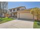 Charming two-story home featuring brick accents, a well-manicured lawn, and a spacious two car garage at 5157 S Sedalia Ct, Centennial, CO 80015