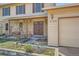 Welcoming front entrance with double doors, brick facade, beautiful landscaping, and a charming porch swing at 5157 S Sedalia Ct, Centennial, CO 80015