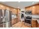 Modern kitchen featuring stainless steel appliances, granite countertops, and ample cabinet space at 5157 S Sedalia Ct, Centennial, CO 80015