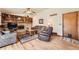Cozy living room featuring hardwood floors, a brick fireplace, and built-in shelving at 5157 S Sedalia Ct, Centennial, CO 80015