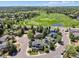 Aerial view of homes, neighborhood and golf course in the distance at 7804 Silverweed Way, Lone Tree, CO 80124
