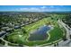 Aerial view of neighborhood, golf course, and lake at 7804 Silverweed Way, Lone Tree, CO 80124