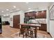 Basement bar features wood counters and cabinets, plus seating for entertaining guests at 7804 Silverweed Way, Lone Tree, CO 80124