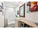 Stylish bathroom featuring marble tiles, a granite countertop, and modern fixtures at 7804 Silverweed Way, Lone Tree, CO 80124