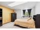 Comfortable bedroom with a skylight and dark wood furniture at 7804 Silverweed Way, Lone Tree, CO 80124