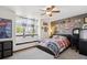 Cozy bedroom featuring a window seat, ceiling fan, and creatively decorated walls at 7804 Silverweed Way, Lone Tree, CO 80124