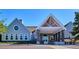 Exterior of building with peaked roof, portico, and stone accents at 7804 Silverweed Way, Lone Tree, CO 80124