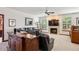 Comfortable living room showcasing a stone fireplace, modern entertainment setup, and inviting leather seating at 7804 Silverweed Way, Lone Tree, CO 80124