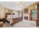 Tranquil main bedroom with a fireplace, large windows, ceiling fan, and neutral decor at 7804 Silverweed Way, Lone Tree, CO 80124