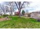 Expansive backyard with lush lawn, mature trees, a garden, and storage shed at 10438 Williams St, Northglenn, CO 80233