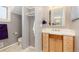 Well-lit bathroom featuring a wood vanity with ample storage and a neutral color palette at 1121 S Ogden St, Denver, CO 80210
