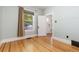 Bright bedroom features gleaming hardwood floors, large window and neutral wall colors at 1121 S Ogden St, Denver, CO 80210