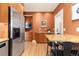 Functional kitchen featuring wood cabinets, stainless steel appliances, and a breakfast bar at 1121 S Ogden St, Denver, CO 80210