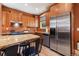 Well-equipped kitchen featuring stainless steel appliances, granite countertops, and wooden cabinets at 1121 S Ogden St, Denver, CO 80210