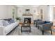 Comfortable living room with stylish seating, wood floors, fireplace and lots of natural light at 1121 S Ogden St, Denver, CO 80210