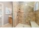 Glass enclosed shower featuring decorative tile surround, shower bench, and built-in shelving at 1121 S Ogden St, Denver, CO 80210