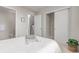 Minimalist bedroom with closet, ensuite bathroom, and natural light at 2436 Welton St, Denver, CO 80205