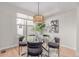 Bright dining room featuring a round glass table, stylish lighting, and modern decor at 2436 Welton St, Denver, CO 80205