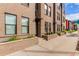 Modern brick townhome featuring large windows, a landscaped entrance, and a clean, urban design at 2436 Welton St, Denver, CO 80205