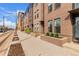 Brick townhomes line the street, with landscaped entrances and modern architecture, reflecting urban living at 2436 Welton St, Denver, CO 80205
