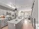 Sleek kitchen featuring stainless appliances, a large island, and modern pendant lighting fixtures at 2436 Welton St, Denver, CO 80205