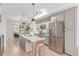 Contemporary kitchen with stainless steel appliances, quartz countertops, and an island with seating at 2436 Welton St, Denver, CO 80205