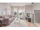 Inviting living room boasts hardwood floors, neutral tones, and large windows for ample sunlight at 2436 Welton St, Denver, CO 80205