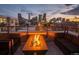 Relaxing rooftop deck featuring a fire pit, comfortable seating, and skyline views at 2436 Welton St, Denver, CO 80205