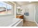 Relaxing bathroom with soaking tub, shower, and updated vanity at 3914 S Perth St, Aurora, CO 80013