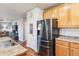 Kitchen with stainless steel refrigerator and wood cabinets at 3914 S Perth St, Aurora, CO 80013