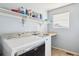 Convenient laundry room with washer, dryer, and shelving at 3914 S Perth St, Aurora, CO 80013