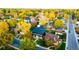 Aerial view of neighborhood showcasing colorful fall foliage, modern home designs, and streets at 1110 Elm St, Denver, CO 80220