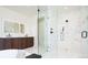 Sleek bathroom with glass shower, double vanity, modern fixtures, and bright lighting at 1110 Elm St, Denver, CO 80220