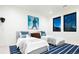 Bright bedroom featuring twin beds with stylish blue and white striped rug and black framed windows at 1110 Elm St, Denver, CO 80220