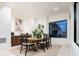 Dining area features a wooden table, modern black chairs, and natural light at 1110 Elm St, Denver, CO 80220