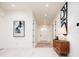 Spacious entryway with hardwood floors, mid-century modern console table, and artwork at 1110 Elm St, Denver, CO 80220