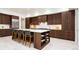 Spacious kitchen island featuring dark wood cabinets and bar stool seating at 1110 Elm St, Denver, CO 80220