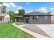 Charming home with a well-manicured lawn, concrete walkway, and inviting front entrance at 3657 Krameria St, Denver, CO 80207